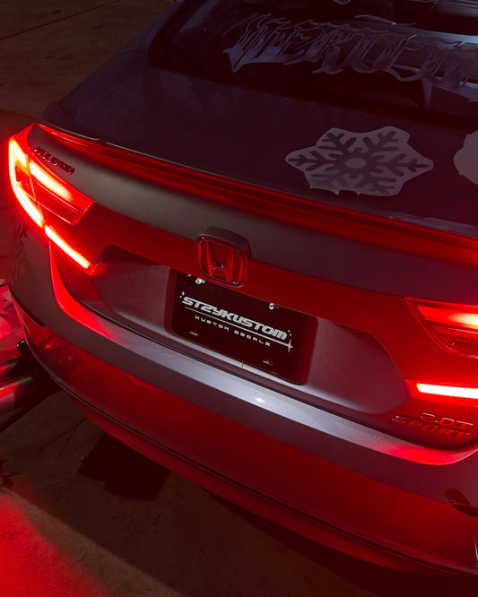 Car with illuminated brake lights on a dark background