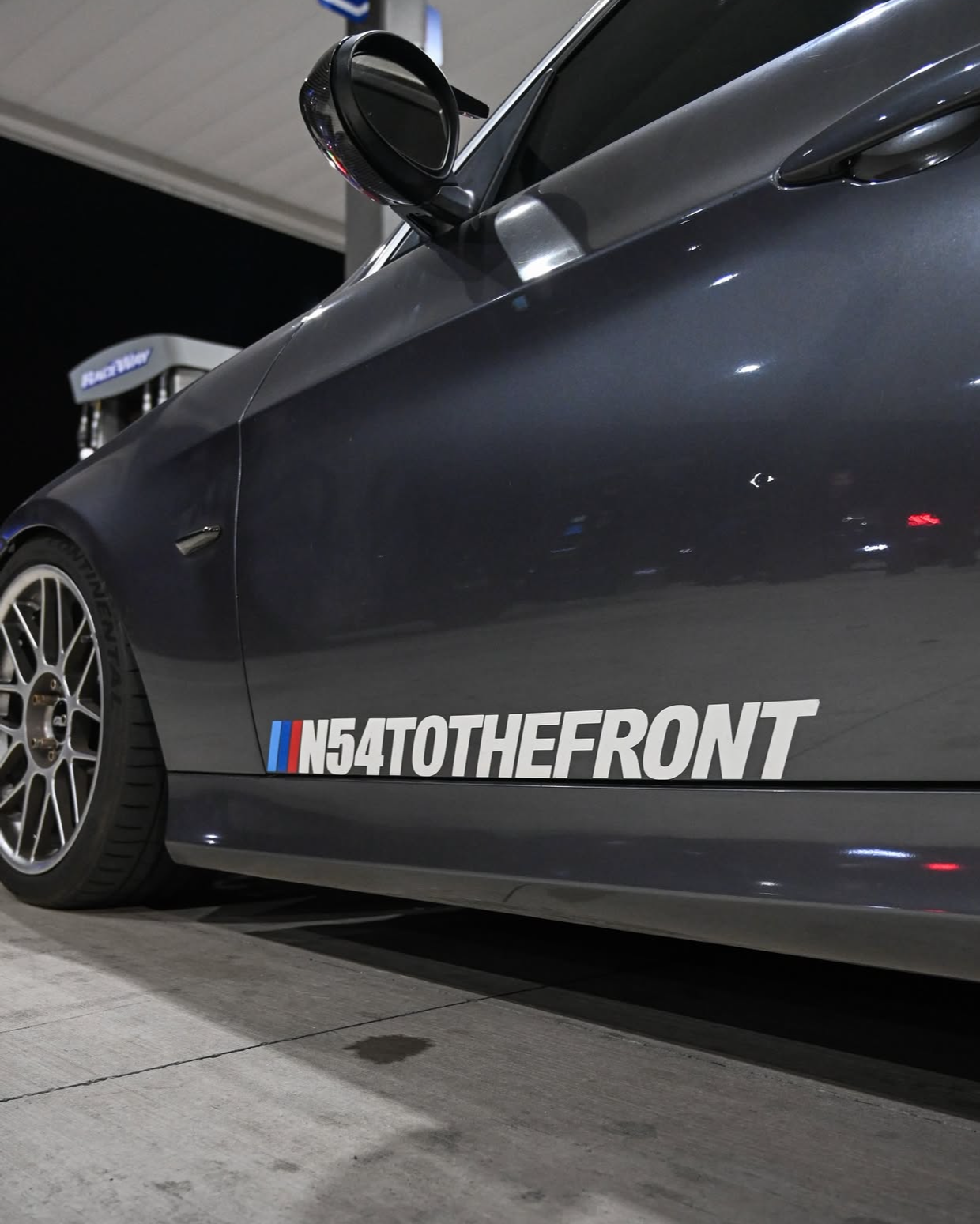 Car with 'N54TOTHEFRONT' decal on a social media post interface.